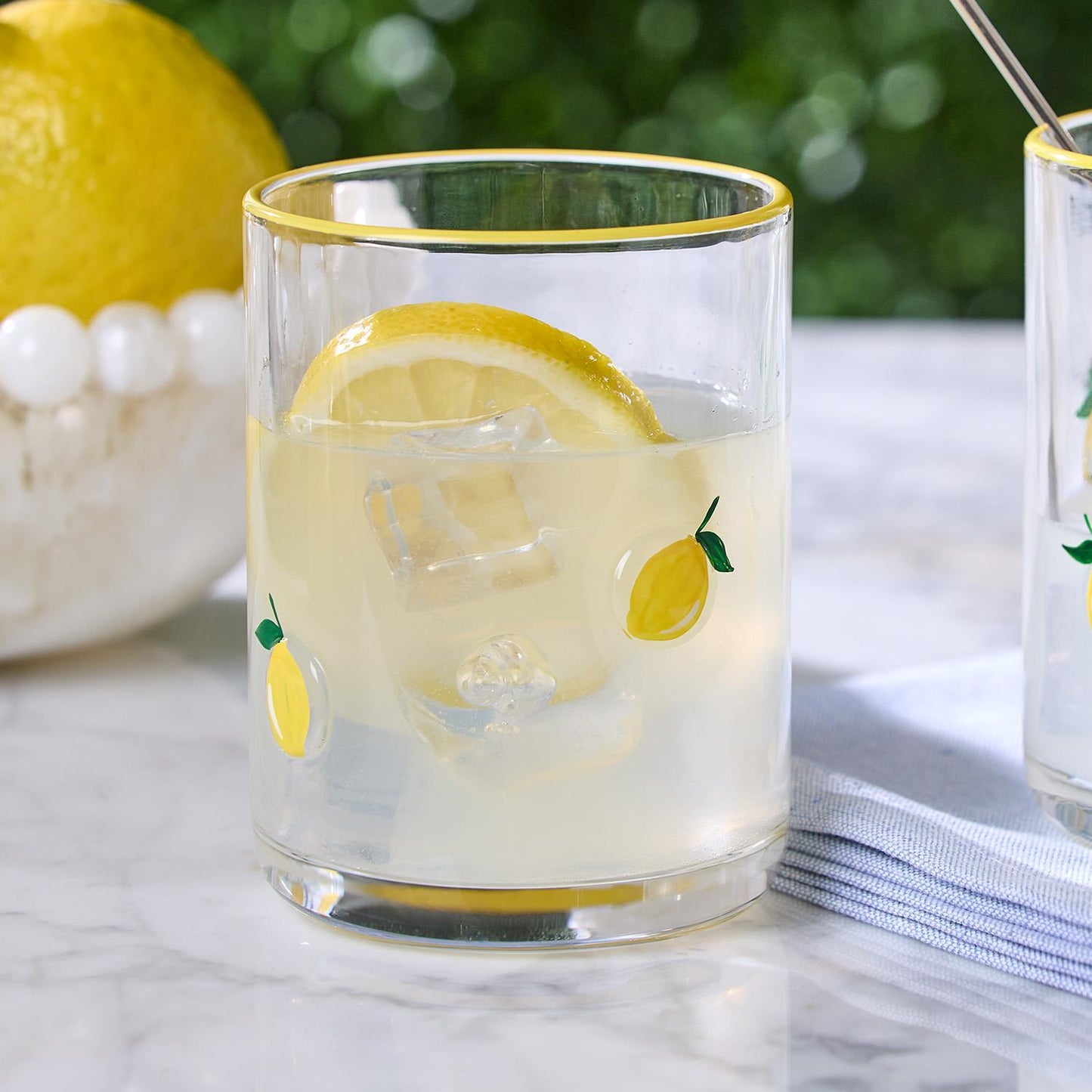 Lemon Double Old Fashion Hand-Painted Glass with lemon design, filled with lemonade and ice. Available in 12oz and 16oz sizes.