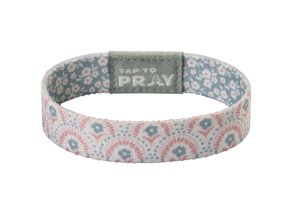 Tap To Pray™ Wristbands - Boho, featuring a pink and blue floral elastic band with a grey “TAP TO PRAY” embossed tab.