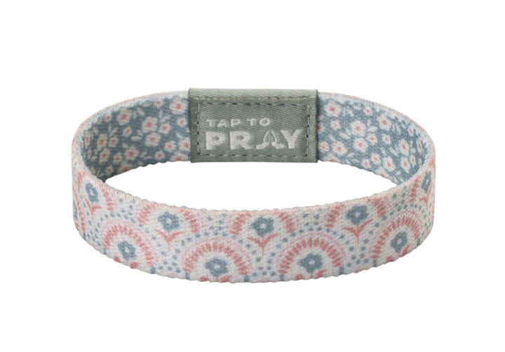 Tap To Pray™ Wristbands - Boho, featuring a pink and blue floral elastic band with a grey “TAP TO PRAY” embossed tab.