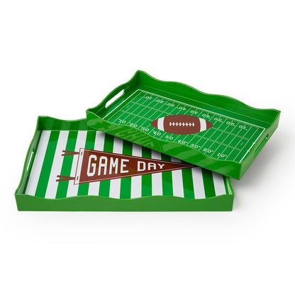 Game Day Decorative Handled Serving Trays, sold separately, available in two green rectangular designs: one with a football field and football, the other with green and white stripes and a "Game Day" pennant. Both feature side handles. Sizes available.