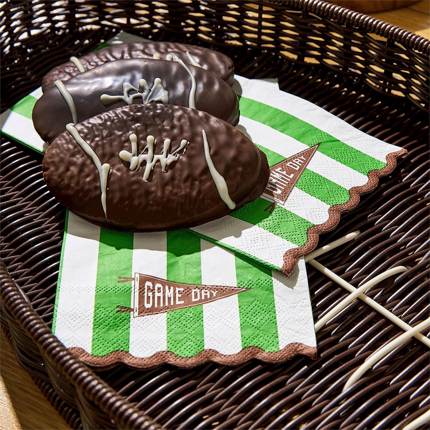 Chocolate football-shaped treats on sticks, available in small, medium, and large sizes.