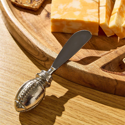 Set of 2 football spreaders with football-shaped handles, each spreader approximately 5 inches long.