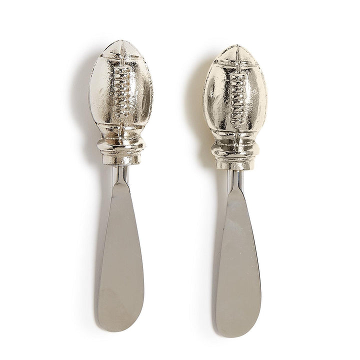 Set of 2 metal spreader knives with American football-shaped handles. No size information available.