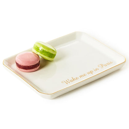 White ceramic trinket tray with gold trim, gold "Wake me up in Paris" script, pink & green macaron. Size info not available.