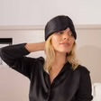 Drowsy Silk Sleep Mask in black on forehead; available in standard and large sizes.