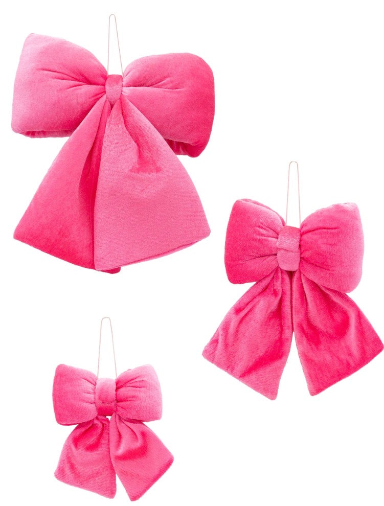 Three pink velvet bows in varying sizes with wire hanging loops.