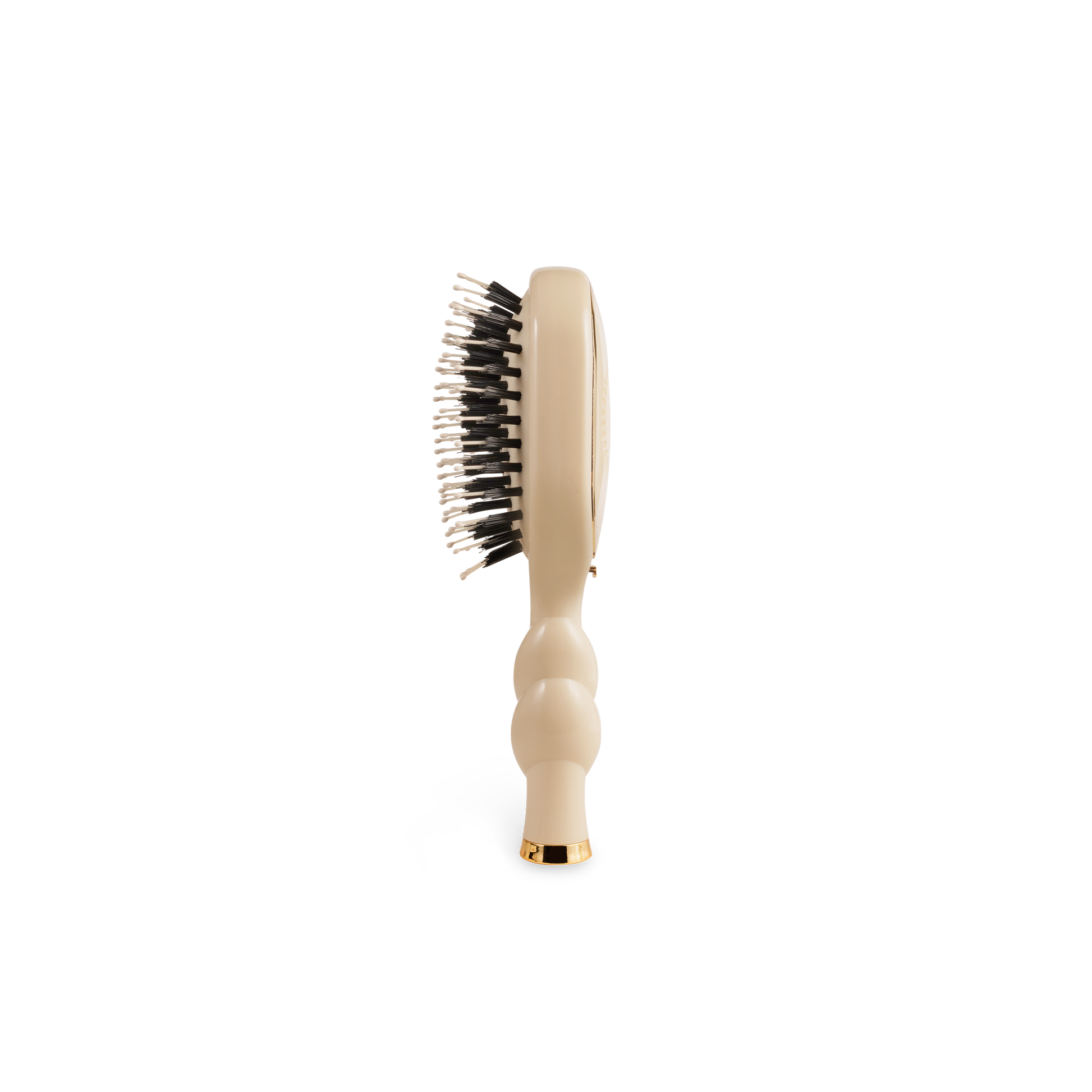 The Mini Boar Brush | Tan has a contoured handle with black and white bristles. Available in mini size.