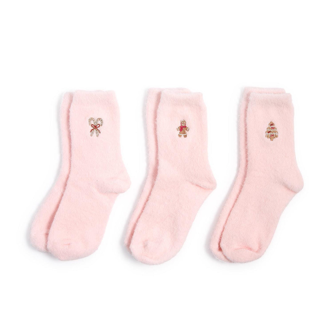 Three pairs of pink Cozy Holiday socks featuring embroidered candy cane, gingerbread man, and Christmas tree icons. Sizes available: One size.
