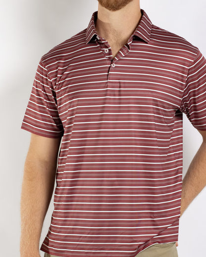 Men’s Maroon Sideline Striped Polo with short sleeves and horizontal red, white, and pink stripes. Available in sizes S-XXL.