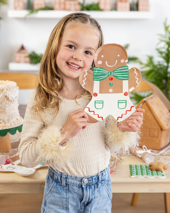 Gingerbread Man Plate shaped as a die-cut gingerbread man with a green striped bowtie and white overalls with red trim.