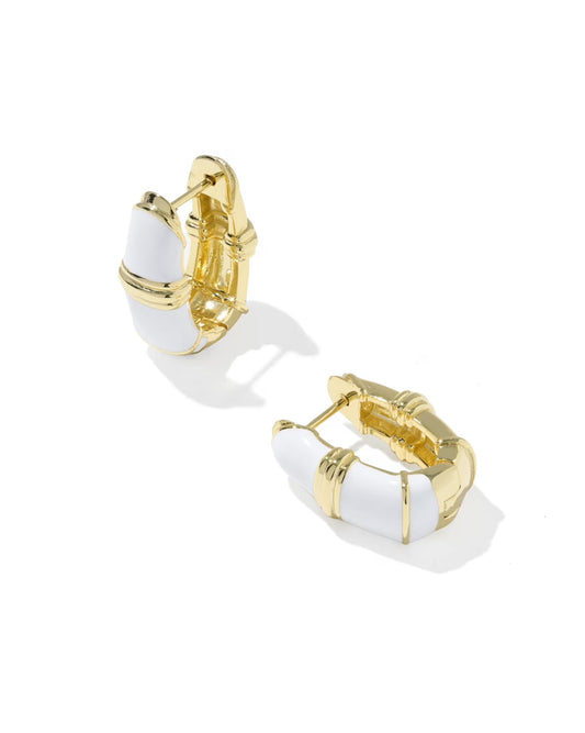 The Courtney Enamel Huggie by Kendra Scott is a pair of gold huggie earrings with white enamel accents, featuring a chunky segmented design and hinged clasps in a classic huggie style. Available sizes: small, medium.