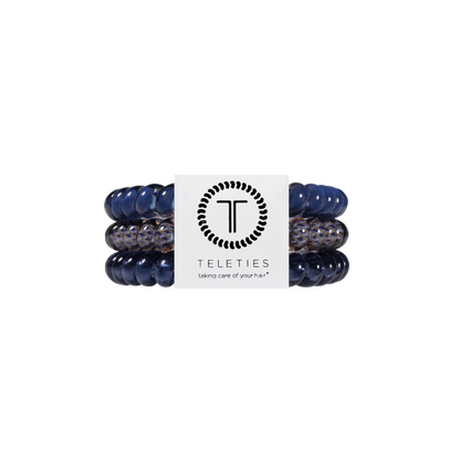 Three Twilight Tones Small Hair Ties with navy and leopard patterns, packaged on a TELETIES card. Available in size small. No-crease design for gentle, secure hold.