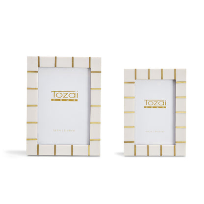 Set of two Brass Lines Photo Frames with white borders, horizontal gold accents, and chic resin design, includes one large and one small size, both featuring "Tozai Home" logo placeholders.