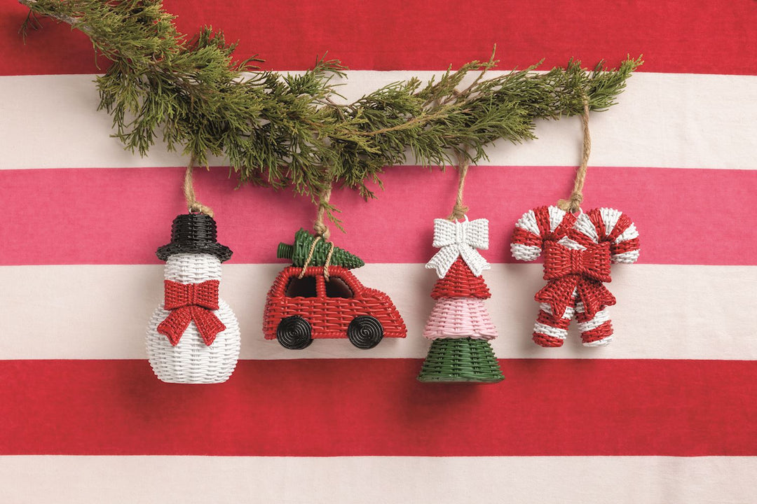 Four resin wicker ornaments: snowman, car with tree, tiered tree with bow, and candy cane.