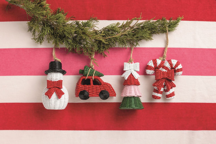 Four resin wicker ornaments: snowman, car with tree, tiered tree with bow, and candy cane.