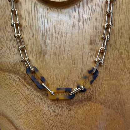 Bold, oversized chain link necklace with marbled brown and gold links. Available in sizes S, M, L.