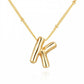 This is a Personalized Bubble Balloon Initial Necklace featuring a high-gloss bubble letter "k" pendant. It's delicately hung on a bead chain. The little bead spacing adds an understate elegance to the piece, making it perfect for daily wear. Available in various sizes to cater different personal preferences.