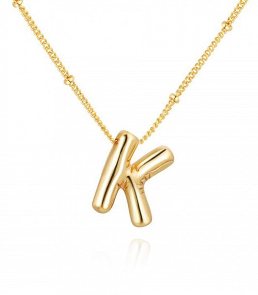 This is a Personalized Bubble Balloon Initial Necklace featuring a high-gloss bubble letter "k" pendant. It's delicately hung on a bead chain. The little bead spacing adds an understate elegance to the piece, making it perfect for daily wear. Available in various sizes to cater different personal preferences.