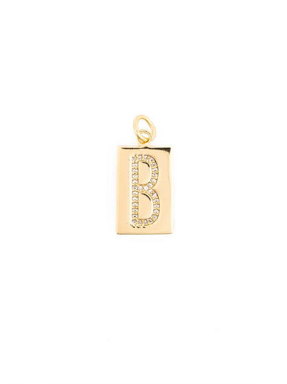 The Thea Charm Bar is an 18k gold plated rectangular pendant with a raised, gemstone-encrusted letter “B” and a small loop for attachment. Available in multiple sizes.