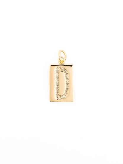 Customizable gold rectangular pendant necklace with the letter “D” in clear stones, 18k gold-plated, hypoallergenic, small loop for chain. Available in multiple sizes.