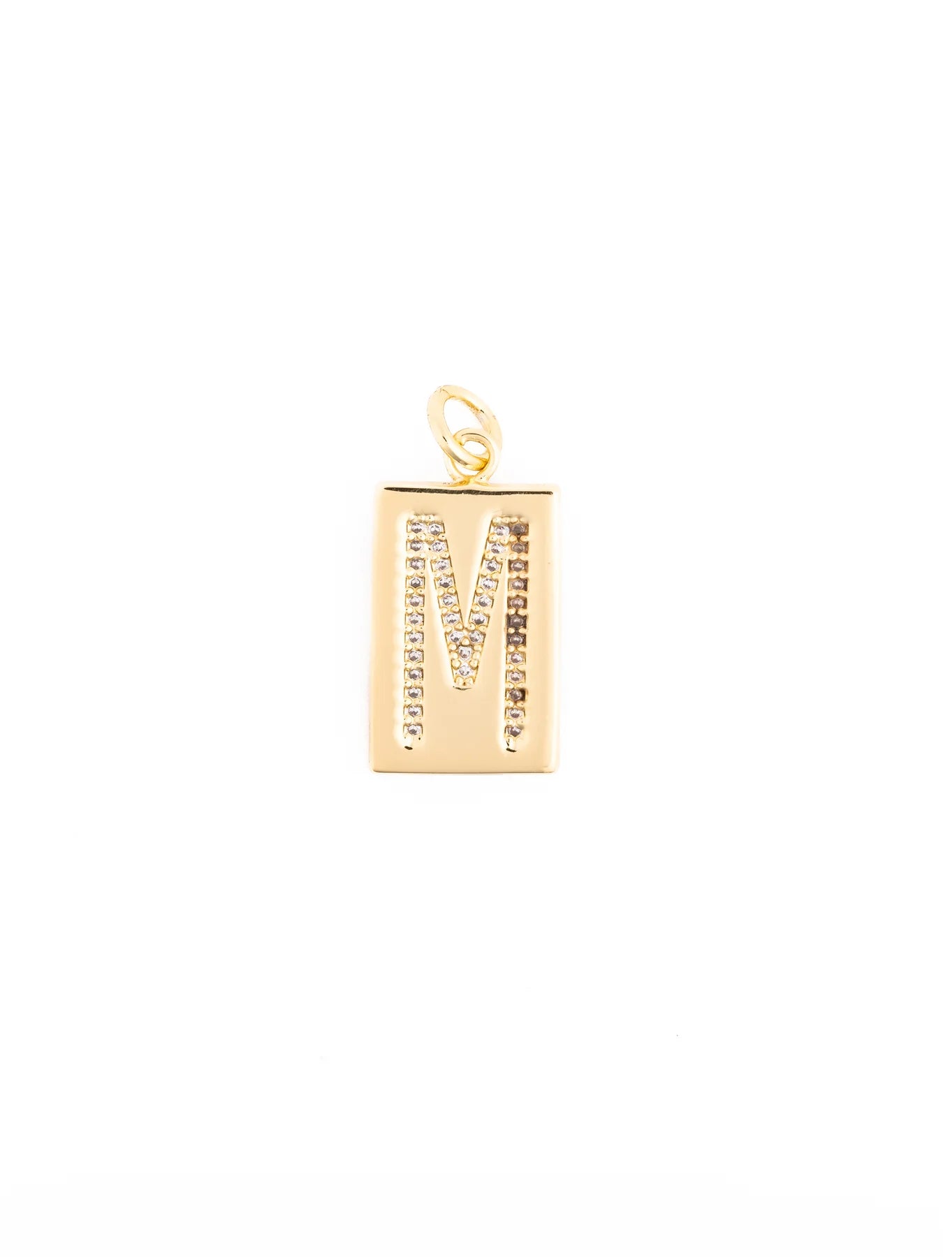 Thea Charm Bar is a rectangular 18k gold-plated pendant necklace featuring the letter “M” outlined with clear stones, hypoallergenic, and designed with a loop for your chain. Available in multiple sizes.