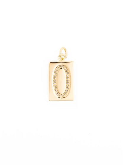 Thea Charm Bar is a gold rectangular pendant with a raised oval design and small clear crystals, plated in 18k gold, hypoallergenic. Available in sizes 16” and 18”.