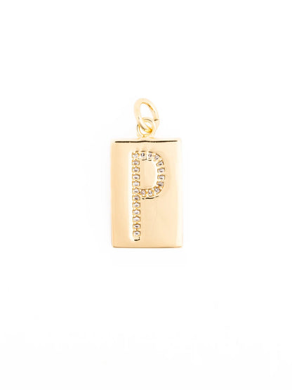 Rectangular 18k gold plated pendant with a loop, featuring the letter “P” in clear gemstones. Available in multiple sizes.