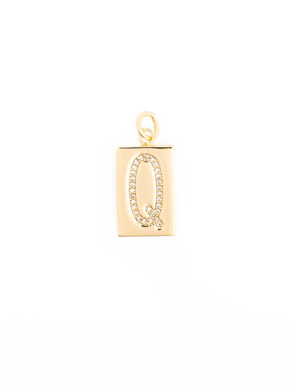 Rectangular 18k gold-plated pendant with a loop, featuring the letter “Q” outlined in clear stones; hypoallergenic. Available in multiple sizes.