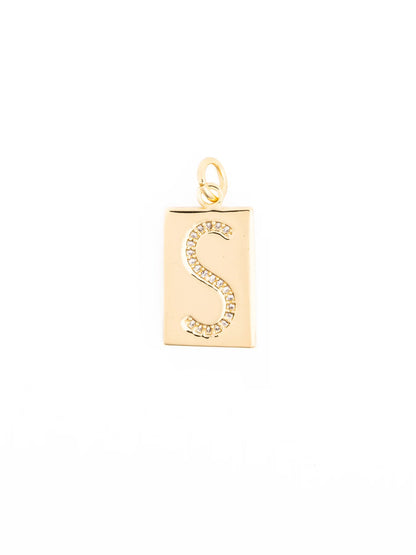 Gold rectangular pendant with diamond-encrusted letter “S” at the center and a small top loop for attachment; hypoallergenic. Available in multiple sizes.