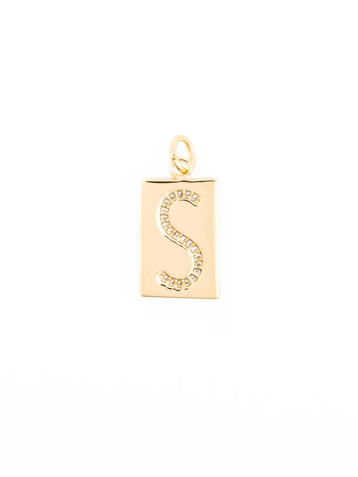 Gold rectangular pendant with diamond-encrusted letter “S” at the center and a small top loop for attachment; hypoallergenic. Available in multiple sizes.