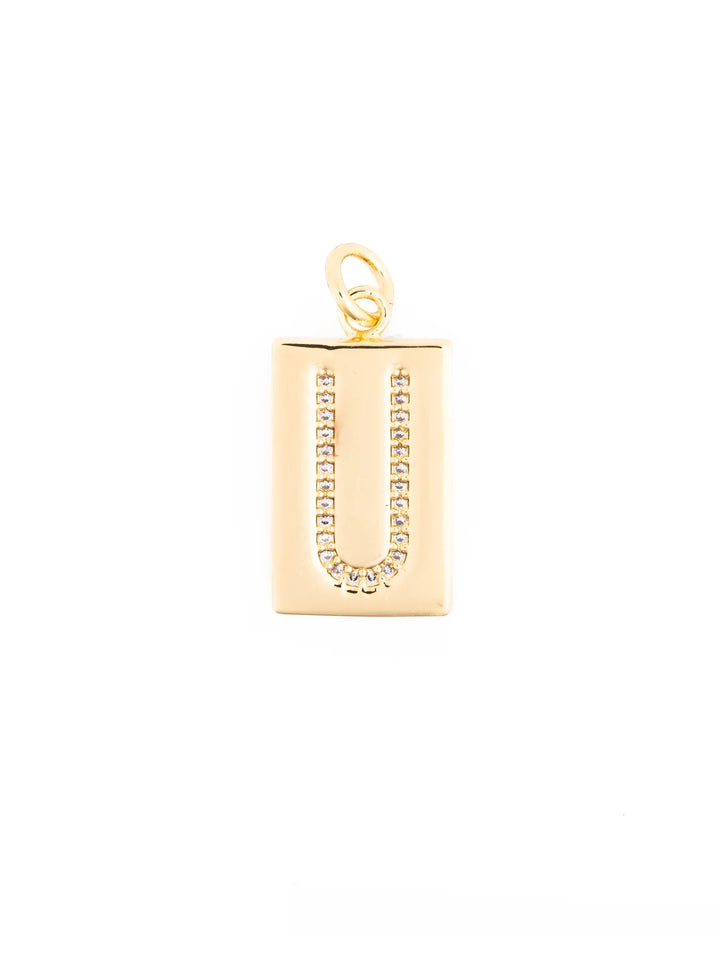 Thea Charm Bar: 18k gold plated rectangular pendant necklace with letter “U” outlined in clear stones and a top loop for attachment. Available in multiple sizes.