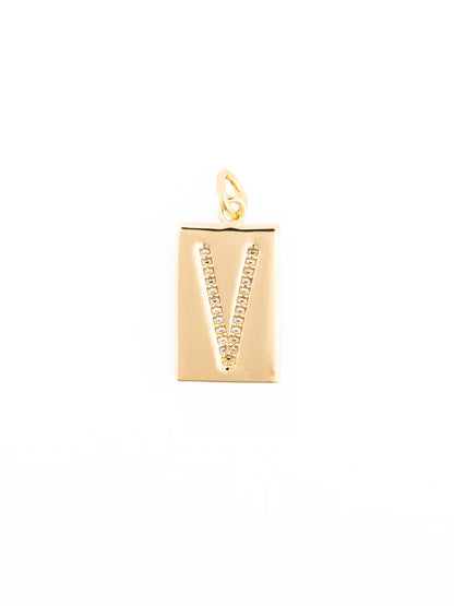 Thea Charm Bar: gold rectangular pendant with letter “V,” clear sparkling stones, 18k gold-plated, loop for attachment. Available sizes: Small (1”), Medium (1.5”), Large (2”).