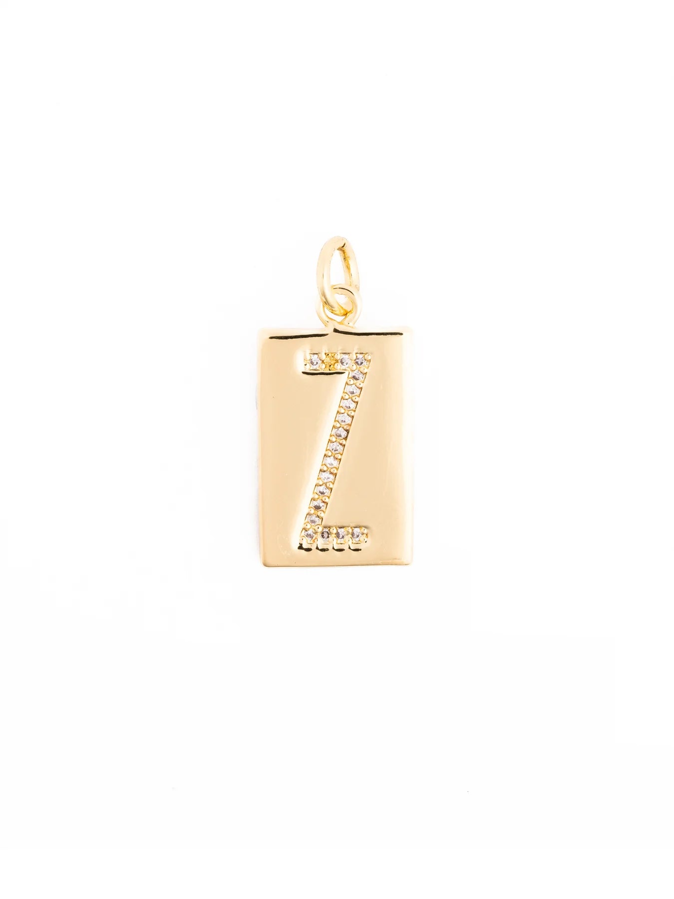 Thea Charm Bar is a rectangular 18k gold-plated pendant featuring a diagonal letter “Z” with clear gemstones, hypoallergenic, with a top loop for easy attachment. Available in multiple sizes.