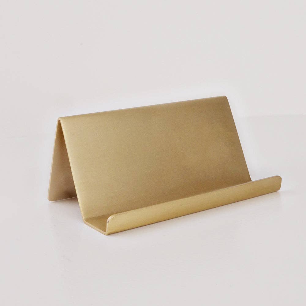 Brass card holder with satin finish, slanted back, and raised lip. Available in small and large sizes.