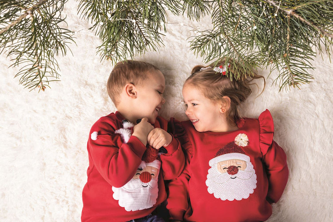 Happy Santa Sweater: red crew-neck Christmas sweatshirt with a sequined Santa face and pom-pom nose. Available in various sizes.