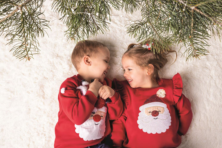 Happy Santa Sweater: red crew-neck Christmas sweatshirt with a sequined Santa face and pom-pom nose. Available in various sizes.