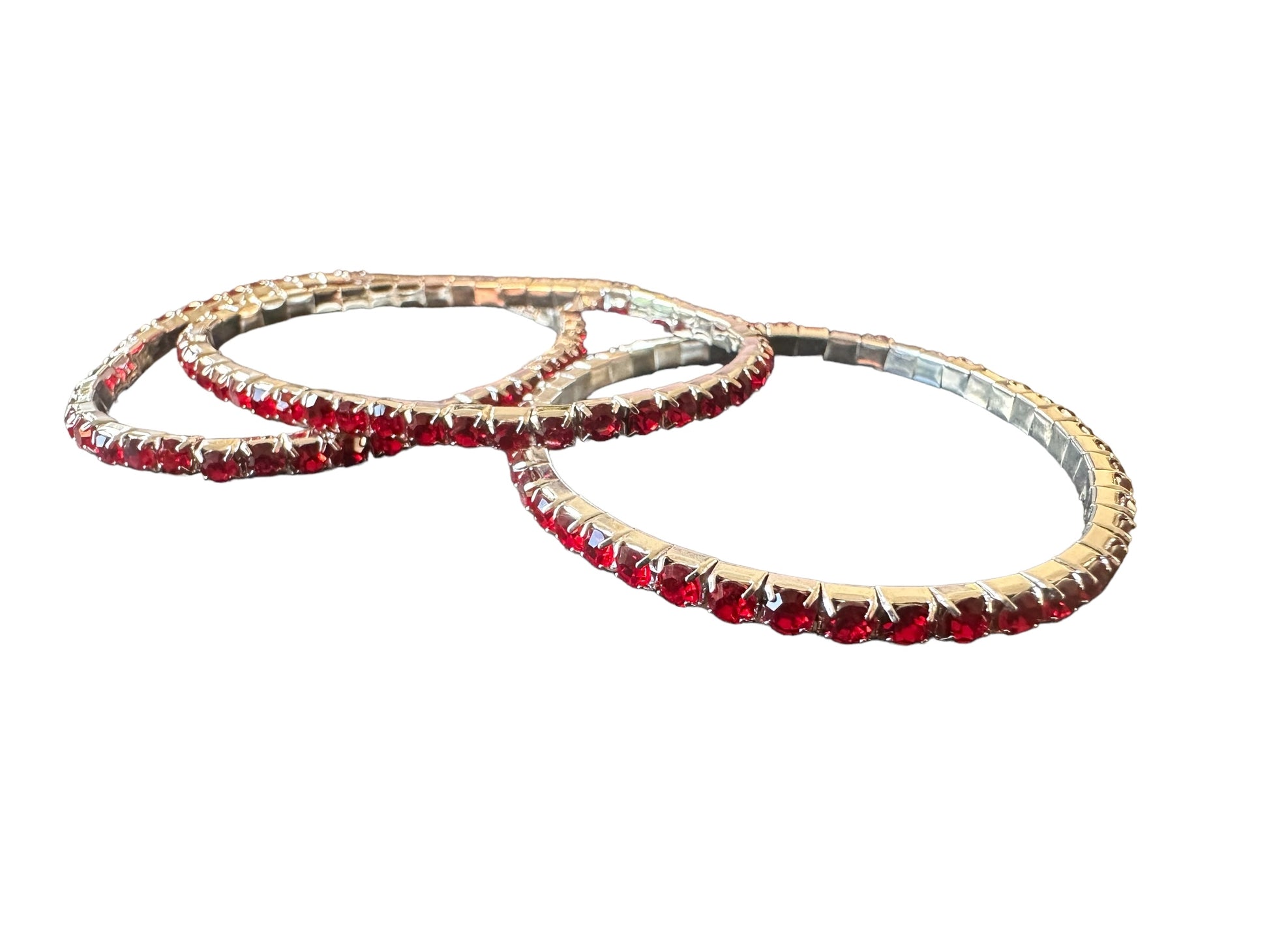 Three dazzling Glitter Bangles adorned with evenly spaced red gemstones. Available sizes: Small, Medium, Large.