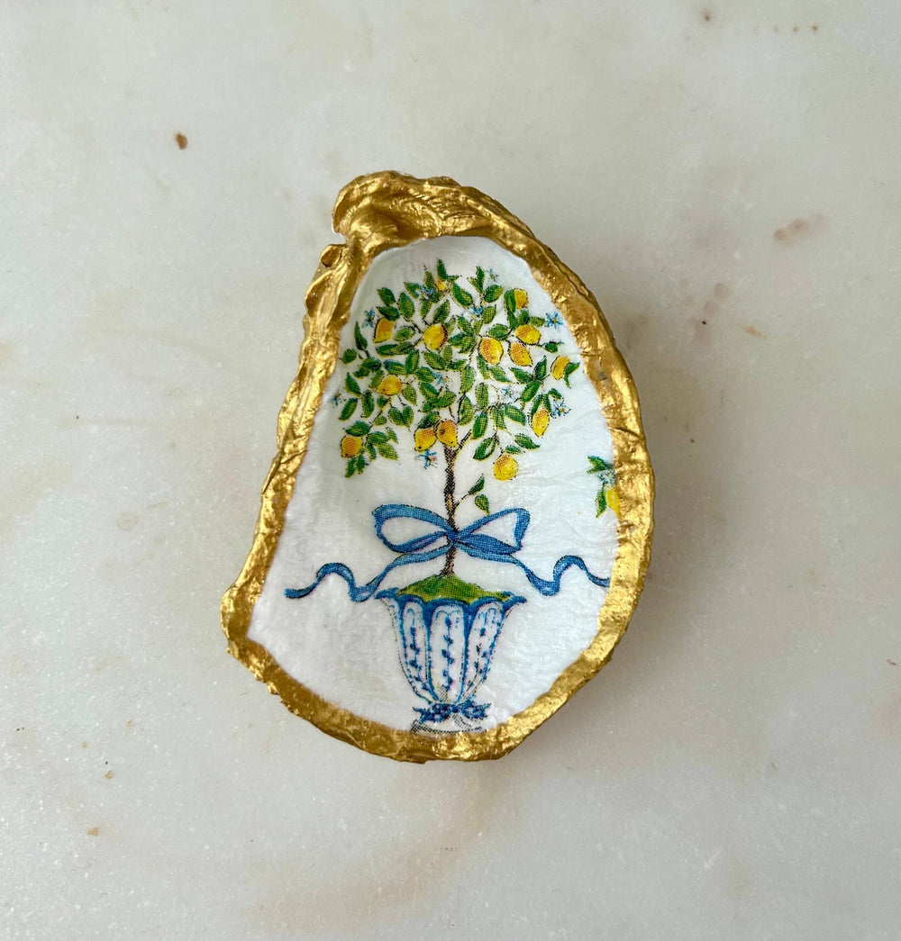 White recycled oyster shell jewelry dish with gold rim, hand-painted lemon tree in blue vase. Sizes: small, medium, large.