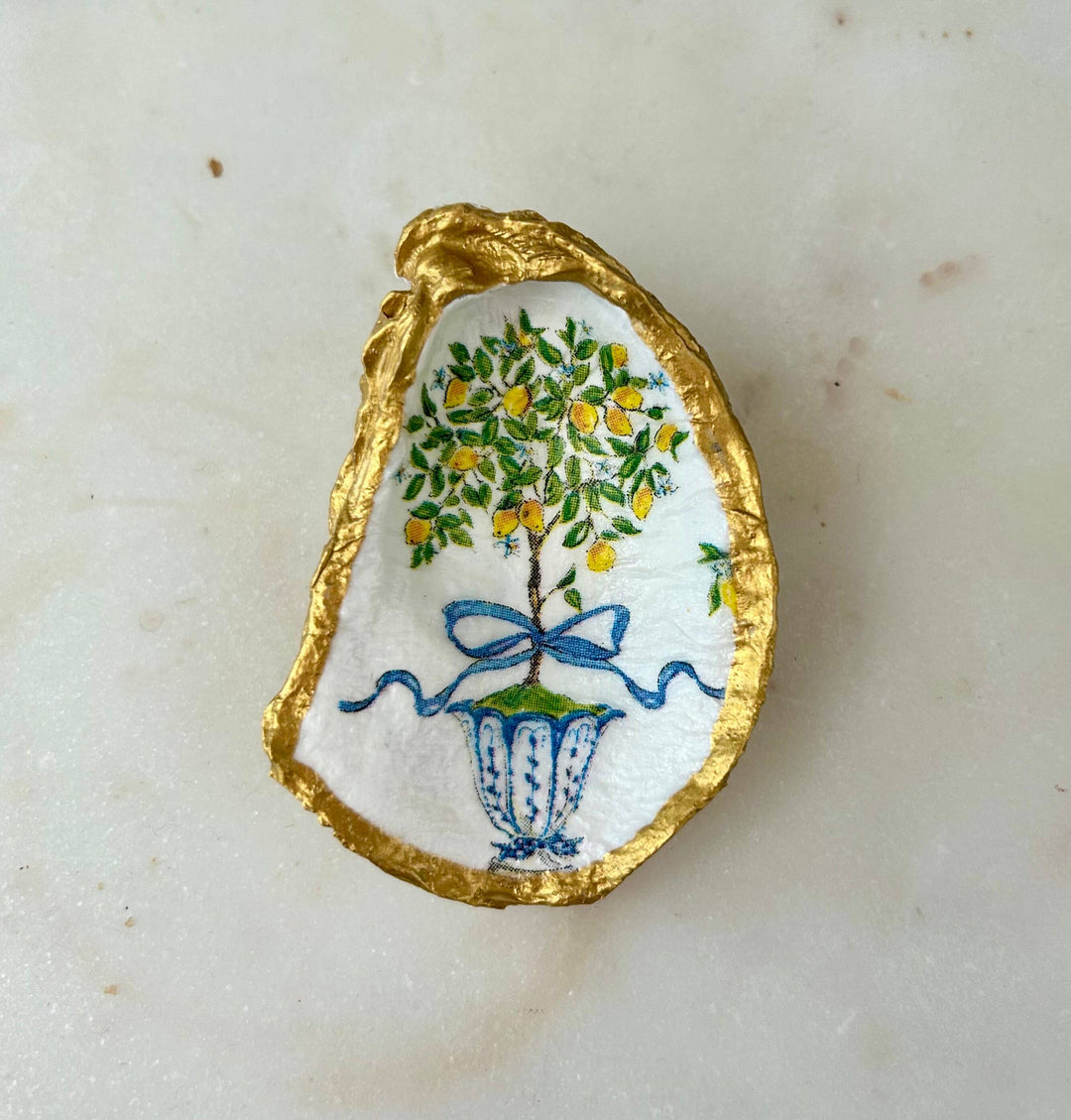 White recycled oyster shell jewelry dish with gold rim, hand-painted lemon tree in blue vase. Sizes: small, medium, large.