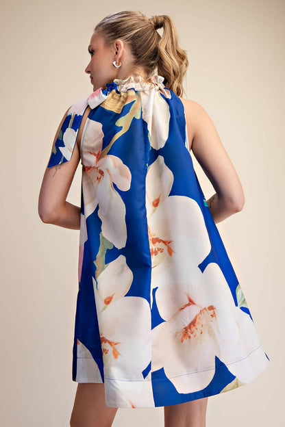 Mini Dress Ruffle Neck Tie Sleeveless Floral Print in Royal with white floral print, available in sizes S–L.