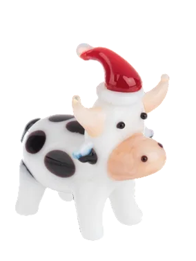 Glass cow figurine with black spots wearing a red Santa hat.