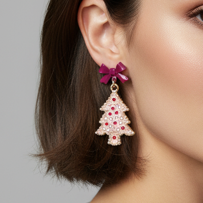 Christmas Tree Bow Earrings shaped like a Christmas tree with a magenta bow and red and white crystals.