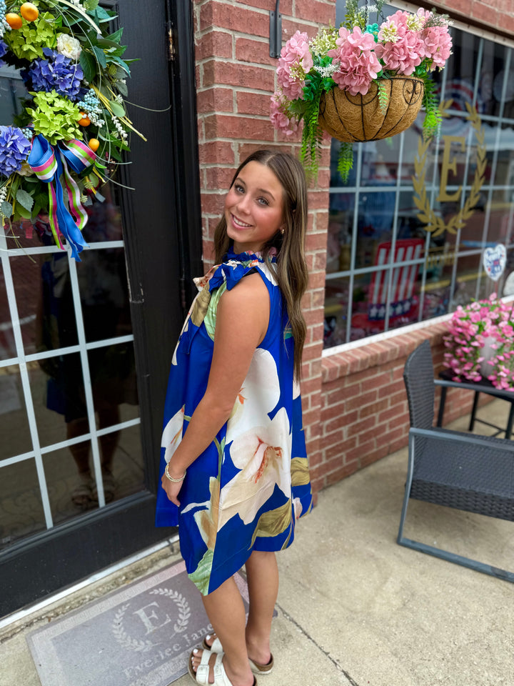 Royal Blue Floral Ruffle Tie-Neck Sleeveless Dress. Available in sizes XS-XL.