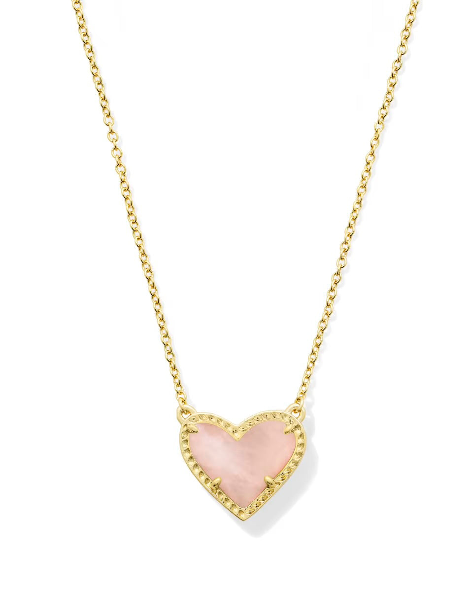 Gold chain necklace with pink heart-shaped gold-bordered pendant, available in small and medium sizes. Inspired by Kendra Scott.