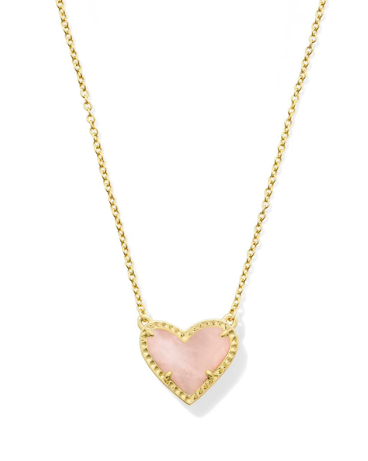 Gold chain necklace with pink heart-shaped gold-bordered pendant, available in small and medium sizes. Inspired by Kendra Scott.