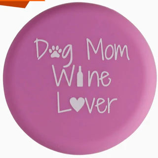 Pink circular coaster with "Dog Mom Wine Lover," paw print, wine bottle, and heart. Available in 4-inch and 6-inch sizes.