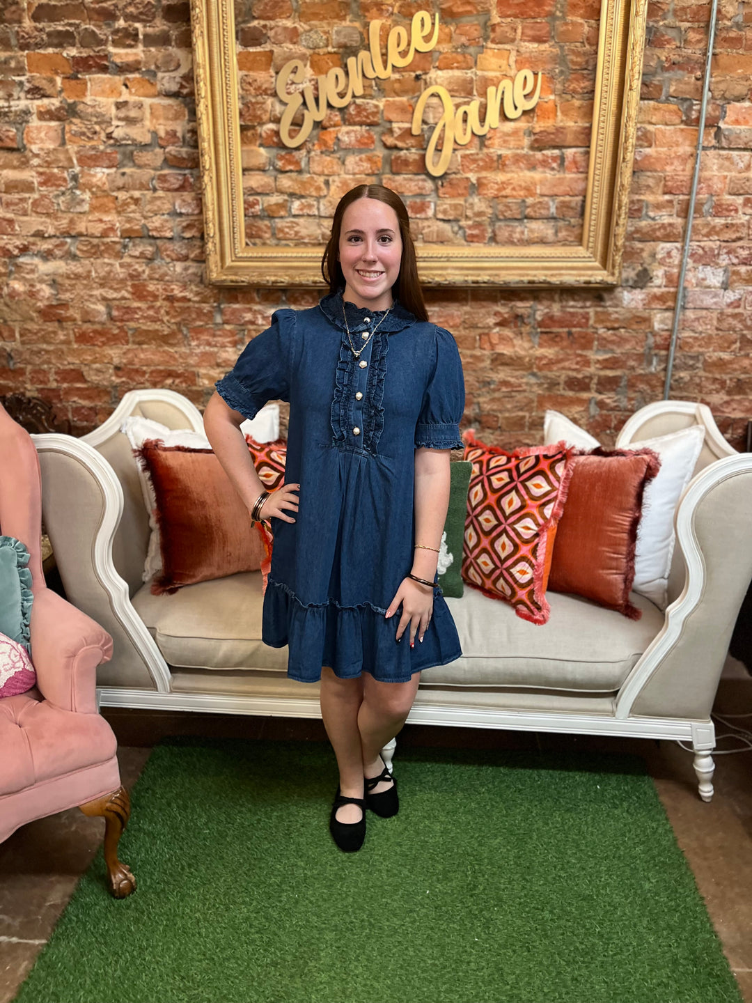 Darcy Ruffle Denim Dress with short sleeves, button-front bodice, and ruffled neckline and hem. Available in multiple sizes.