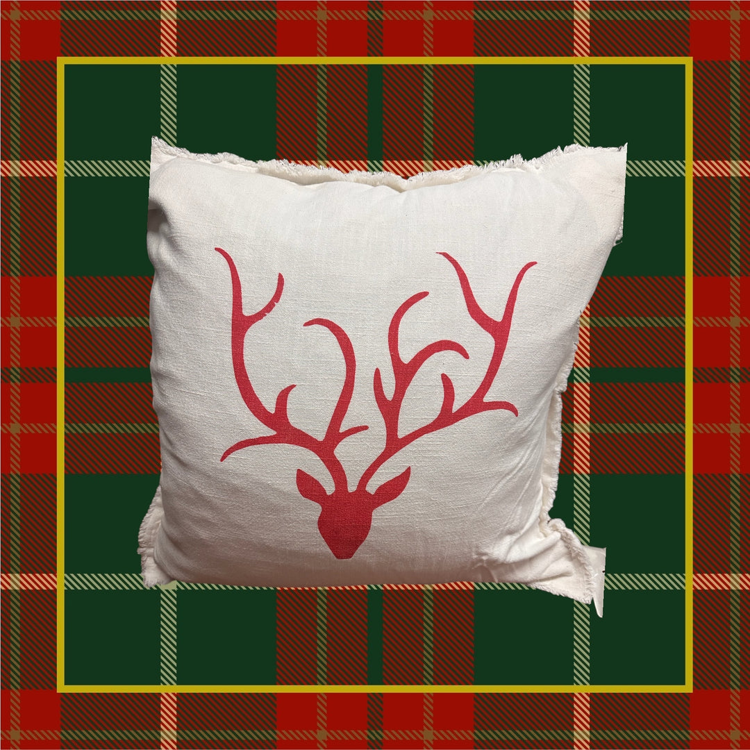 Cream-colored square Euro pillow with red stag antlers print and frayed edges.