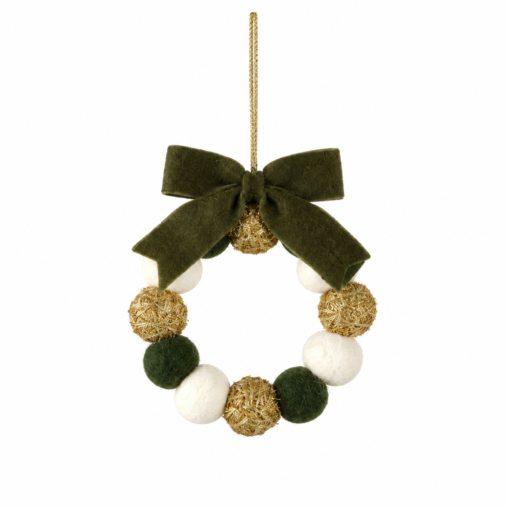 Wreath-shaped ornament with green felt, white felt, and gold glitter pom poms, finished with a dark green velvet bow and a gold hanging loop.