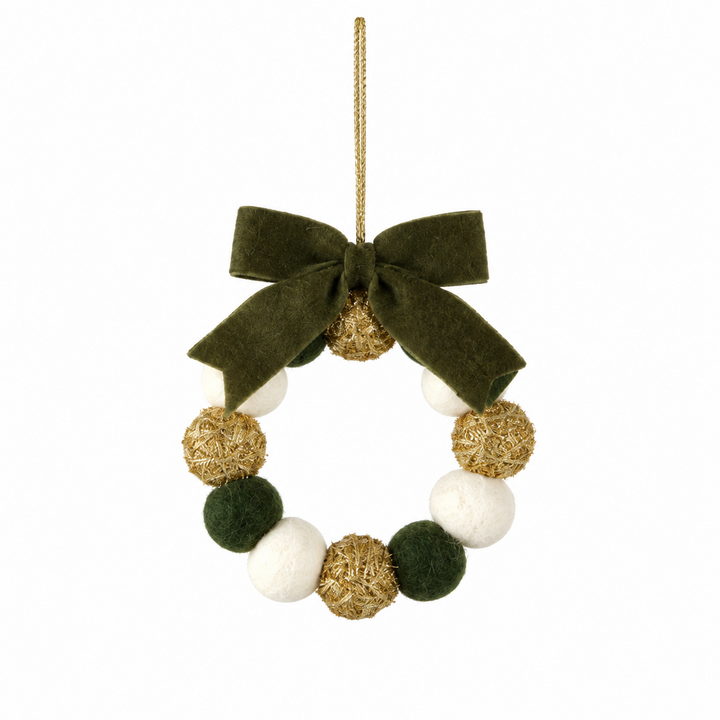 Wreath-shaped ornament with green felt, white felt, and gold glitter pom poms, finished with a dark green velvet bow and a gold hanging loop.